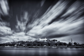 Canvas Print - Bratislava Castle & St Martin's cathedral near Danube river with long exposure cloud movement