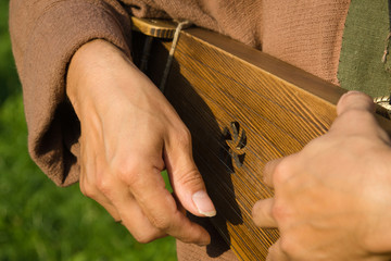 Wall Mural - Kantele finnish folk musical instrument in man hands