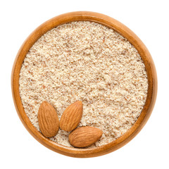 Wall Mural - Shelled and ground almond nuts in wooden bowl. Edible, dried, brown seeds of Prunus dulcis. Ingredient in marzipan, nougat, cookies. Isolated macro food photo close up from above on white background.