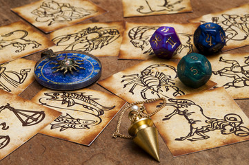 Wall Mural - zodiac signs in old style with magic pendulum, blue horoscope ring and astrology dice
