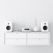 Modern audio stereo system with white speakers on bureau in modern interior, 3d rendering