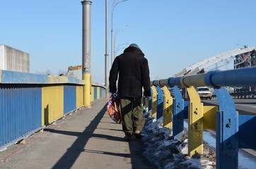 homeless man walking on the bridge