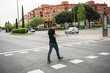 Boy walking by a pedestrian crossing with the phone