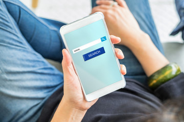 search button and address bar on mobile screen with woman holding mobile phone searching for data on