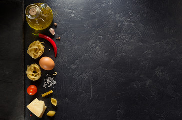 Canvas Print - pasta ingredients on black background