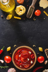 Poster - tomato sauce in bowl on black background