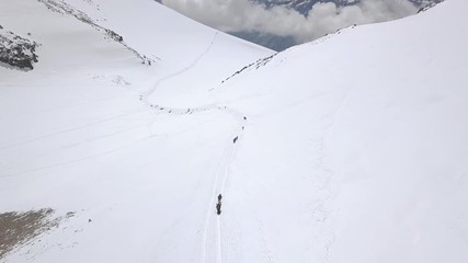 Wall Mural - tourist group climbing a snow mountain peak during winter trip