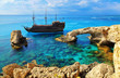 The bridge of love or love bridge. Pirate ship sailing near famous Bridge of Love near Ayia Napa, Cyprus.