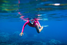 Young Woman Underwater Swimming In Tropical Ocean