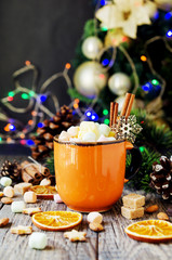 Wall Mural - a cup of Christmas hot cocoa with marshmallow New Year's lights and decorations, selective focus