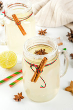 Fall And Winter Drinks. Christmas Holiday Beverage. Festive Snowball Cocktail With Lime Juice, Cinnamon, Liqueur, Sugar And Anise Stars. On White Table With Christmas Decoration, Copy Space
