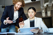 © pressmaster - Young successful analysts having discussion of business strategy while analyzing or upgrading statistics