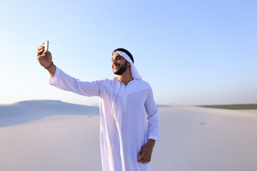 Wall Mural - Portrait of Arabian sheikh man with gadget that communicates in 