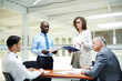 © pressmaster - Mature and young businessmen discussing reports of their intercultural colleagues at briefing