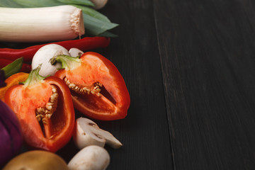 Wall Mural - Fresh bell pepper, mushrooms and leek on wooden background