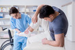 © Elnur - Doctor and patient during check-up for injury in hospital