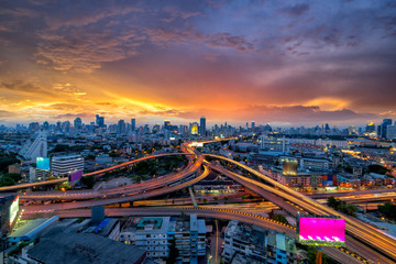 Wall Mural - Bangkok business district  Expressway and Highway top view, Thailand at sunset