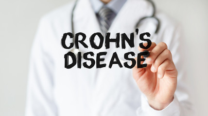 Wall Mural - Doctor writing word Crohn's disease with marker, Medical concept