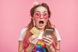 Astonished amazed stylish fashionable woman with two pony tails and pink trendy sunglasses realizes that she is short of money, has no opportunity to make purchase online. Interent and shopping