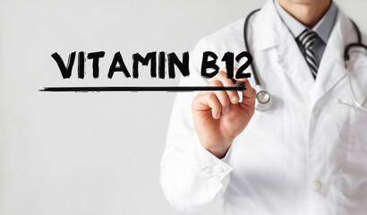 Wall Mural - Doctor writing word Vitamin B12 with marker, Medical concept