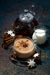 Wall Mural - spicy masala tea and cookies on a dark background, vertical