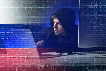Wall Mural - Hacker with computer and laptop on dark background