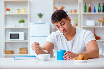 Canvas Print - Man falling asleep during his breakfast after overtime work