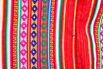 close-up macro of colorful handmade fabric with peruvian motifs