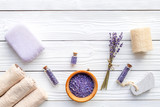 Fototapeta Sypialnia - Set for foot spa with lavender. Flowers, spa salt, pumice stone, soap on white wooden background top view copyspace
