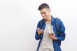 © carballo - college adolescent student with books and mobile phone on wall background
