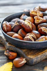 Wall Mural - Roast chestnuts in a pan closeup.