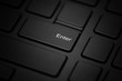 The enter key on a black laptop is close-up.