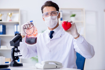 Doctor working with blood samples in hospital clinic lab