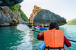 © yongkiet - Group of tourists on a kayak.Travel by boat around Ko Phi enjoy the beautiful nature of the sea and islands in the summer at Mu Ko Ang Thong National Marine Park, Surat Thani, Thailand