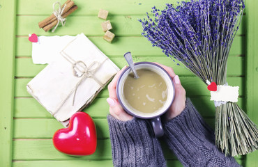 Girl drinking hot coffee and looks flower bouquet