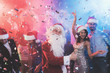 © VadimGuzhva - A man dressed as Santa Claus has fun at a New Year party. Together with him have fun friends.