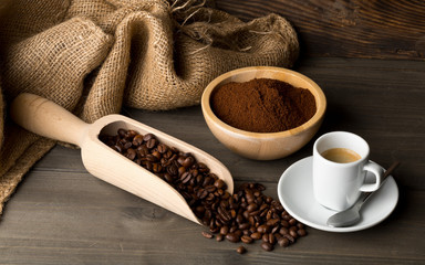 Coffee beans, ground coffee powder and cup of espresso