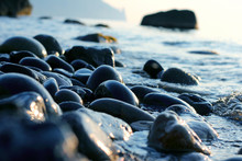 Wet Pebbles On The Sea Shore Closeup.