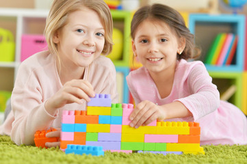 Wall Mural - girls playing with colorful blocks