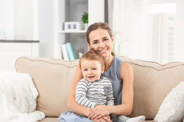 Poster - Mother with baby boy on sofa at home