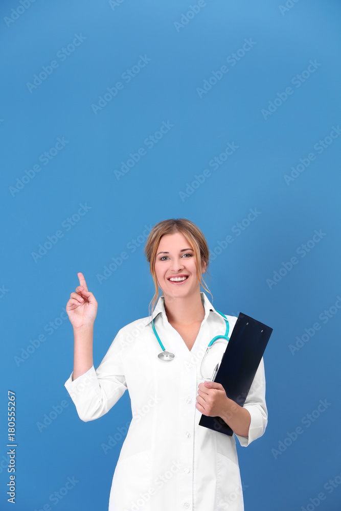 Doctor with clipboard on color background