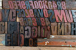 © PAOLO - black, red and brown fonts made of wood and embossed in a wooden wall. stamps placed on a wooden wall. Different typed letter letters with different styles, bold, plain and italic