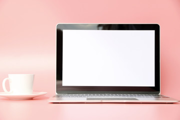 Laptop Workspace on Pink background in Office.