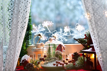 christmas decoration with winter scene in glass dome and lanterns
