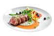 © Maxim Khytra - Delicious medium rare meat steak with sauce and salad on a plate. Healthy food made of meat fillet and fresh herbs isolated on a white background.
