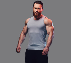 Wall Mural - Bearded bodybuilder dressed in a tank top.