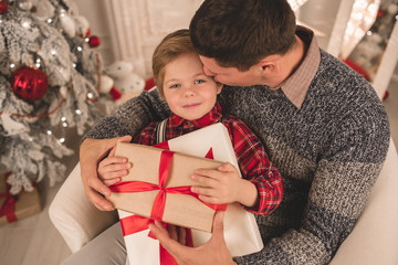 Father with son at home on Christmas evening