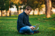 © Aleksandr - The young manager working on a laptop in the park. Lunch Break.