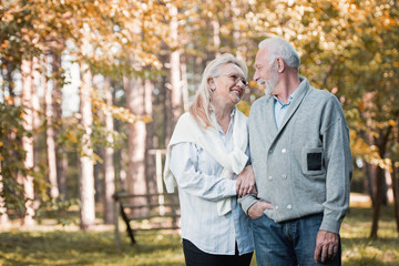 Wall Mural - Happy senior couple smiling outdoors in nature, having fun  