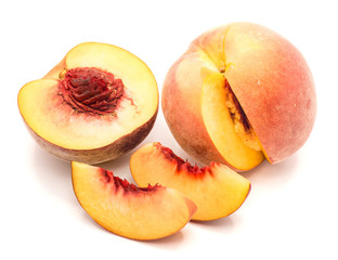 Peaches, one half and cut open, two slices, isolated on white background.